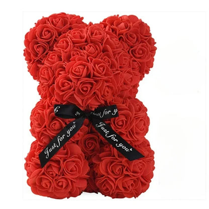 A red teddy bear made out of eternal flowers.